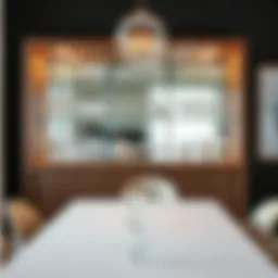 Elegant wall cabinet showcasing fine glassware in a modern dining room setting.